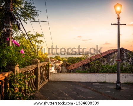 View of the historic city of Olinda with its buildings dated from the 17th century and Recife, the capital of the state on the background at sunset.