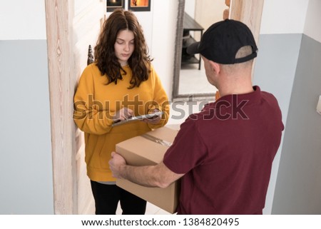 Courier delivering a parcel, delivery man 