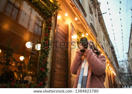 Female photographer outdoors on Christmas eve
