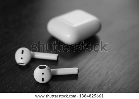 Air Pods. with Wireless Charging Case. New Airpods 2019 on black background. Airpods. Copy space .EarPods