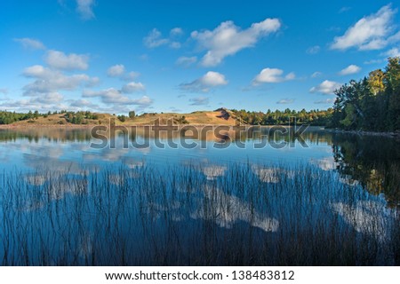 Summer clouds passing over Grand Sable Lake in the Pictured Rocks National Lakeshore  Royalty-Free Stock Photo #138483812