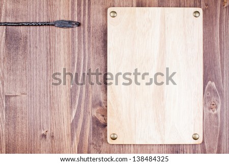 Wooden sign board with nails on planks wall background