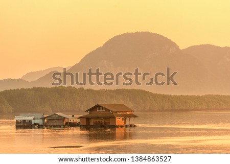 Beautiful sunrise landscape view of fisherman village and wooden boat in early morming at Samchong-tai fishing village in Phang-Nga,Thailand