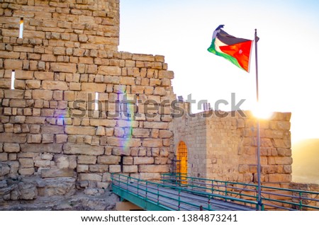 kerak castle entrance with jordanian flag waving