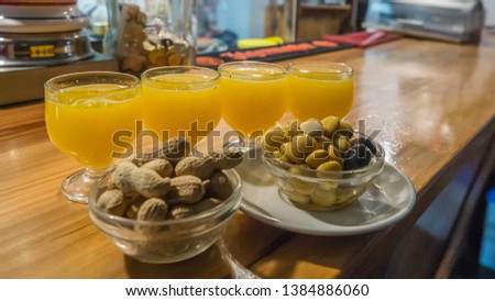 Traditional fresh alcoholic drink Poncha, made from tangerines, honey and white Rum. Madeira, Portugal. Royalty-Free Stock Photo #1384886060