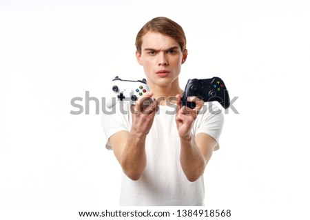 Nice guy with joysticks in the hands of a video game computer