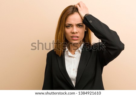 Young caucasian business woman tired and very sleepy keeping her hand on her head.