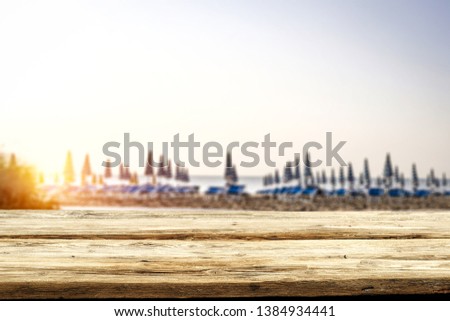 Table background of free space and summer blurred beach landscape. Free space for your decoration. 