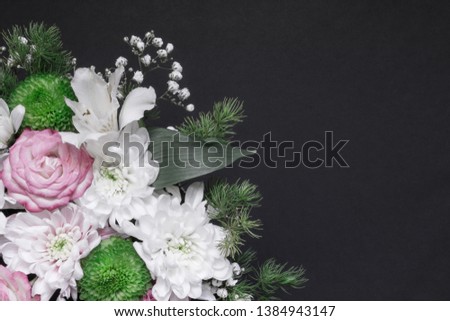 Floral arrangement on dark background with copy space for text. Flowers composition closeup. Flat lay, top view