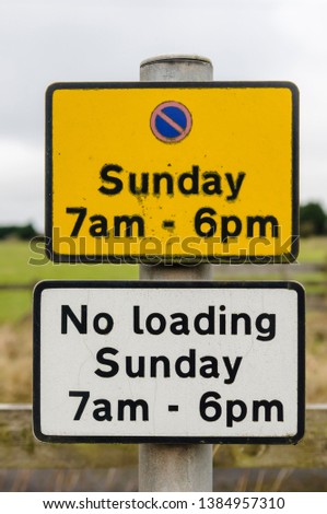 Sign advising motorists that there is no parking in this area on Sundays from 7am to 6pm.