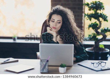 Close up photo serious real estate agent representative occupation sit chair use user gadget pc hesitate try make choice decision pensive contemplate classic jackets wavy curly hairstyle interior