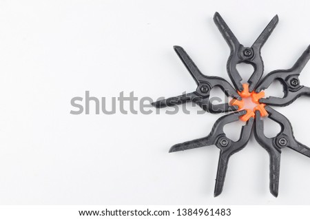 Plastic clip used in photo studio for clamp background. Selective focus.