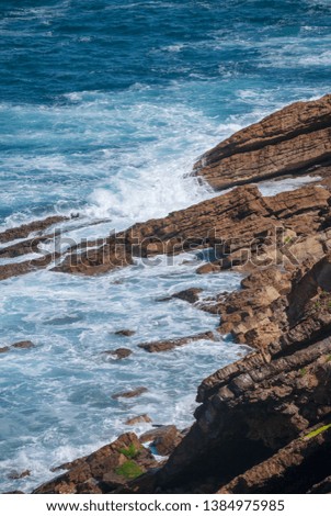 Vertical landscape with waves against the rocky coast in northern Spain