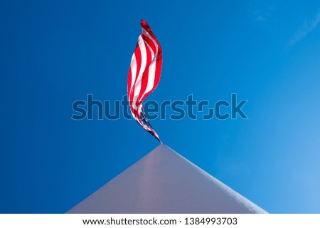 Abstract American Flag waving in wind. American flag isolated on flagpole. 