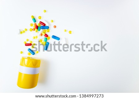 Pill bottle with assorted pharmaceutical medicine pills, tablets, capsules on white background top view. Medical pharmacy background. Flat lay