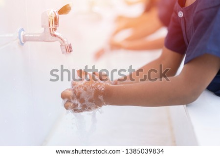 close up hands of children or Pupils At preschool Washing hands with soap under the faucet with water,copy space for text or product you. clean and Hygiene concept. Royalty-Free Stock Photo #1385039834