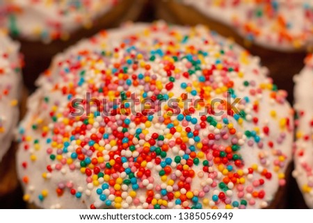 Easter cake with multicolored icing and sprinkles at the spring holiday