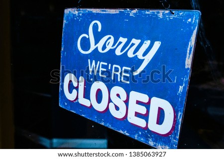 Sign on a shop saying "Sorry. We're closed"