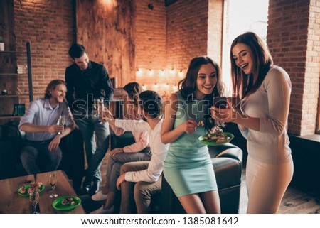 Close up photo friendly event six company buddies telephone look pictures she her ladies he him his guys wineglasses golden wine beverage wear dresses shirts formalwear sit sofa loft room indoors