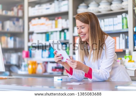Medicine, pharmaceutics, health care and people concept - Pharmacist holding a tablet and box of medications. Pharmacist holding computer tablet Using for filling prescription in pharmacy drugstore. 