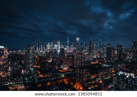 Entire futuristic city skyline view of downtown Toronto Canada during a storm. Modern buildings, urban architecture, cars travelling. construction and development in a busy city.