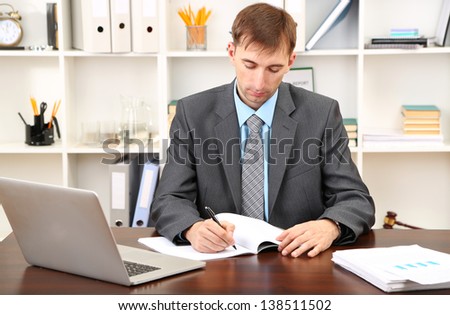 Young businessman in office at his workplace