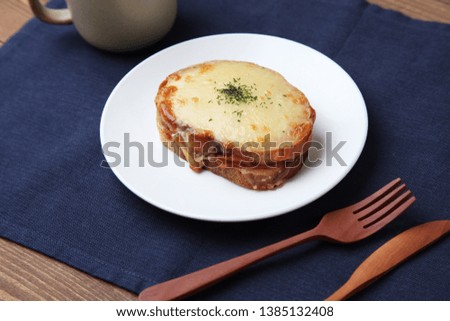 croque monsieur ham cheese sandwich on plate isolated on wooden table