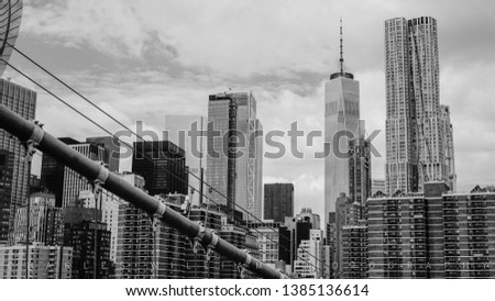 Taken while walking across the Brooklyn Bridge. Amazing view of the Financial District in NYC with a cable from the Brooklyn Bridge in the shot. Combining great engineering with a great view. 
