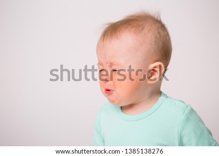 baby boy 6 months crying on white background