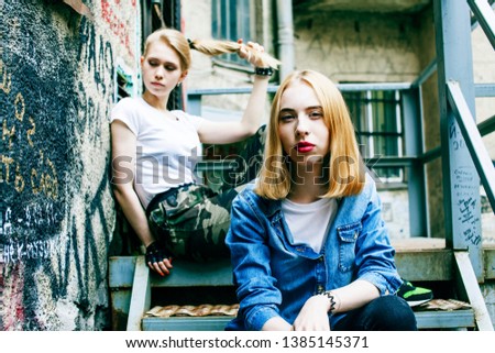 couple of teenage girls ouyside on streets chilling, lifestyle people concept