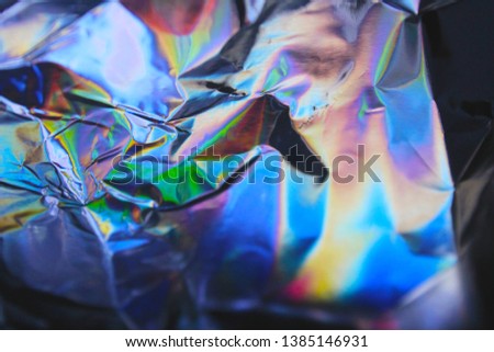 Holographic iridescent foil texture background. It can be used for posters, cards, flyers, brochures, magazines and any kind of cover 
