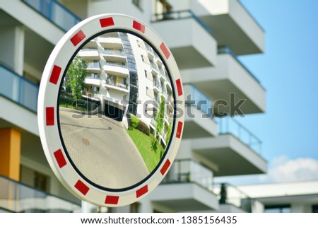 A round mirror surrounded by apartment building