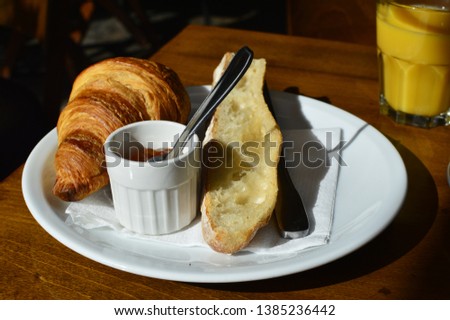 French Breakfast with croissant jam and coffee, and the orange juice