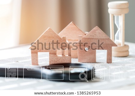 Real estate propery concept : Digital document file marketing icons on wood house model with hourglass. Ideas for offers of mortgage loan investment and management for loan agreement to buy new home