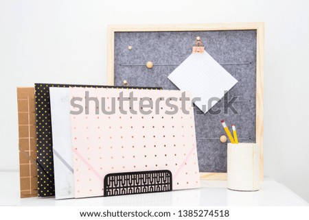 Image of grey felt pin board, trendy folders and pencils illustrating a busy day ahead in the home office.  Bright and airy photo perfect for the glamorous modern day blog, website or brochure.