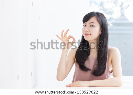 young woman showing OK sign
