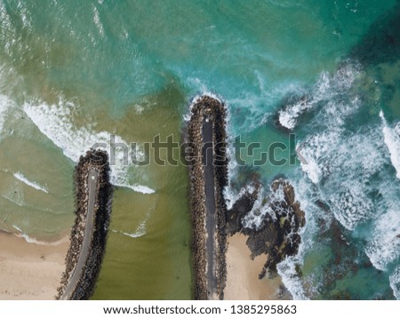 The mouth of a river entering the ocean and the two waters are mixing together