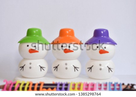 beautiful snowman with colorful caps