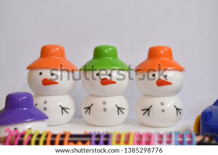 beautiful snowman with colorful caps