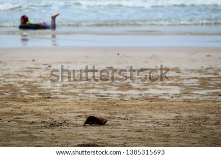 Happy young girl with swim ring on sea waves.