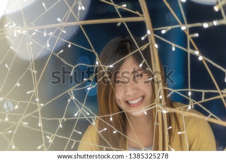 Closeup Portrait of asian woman with light at night, merry christmas and new year celebratation concept