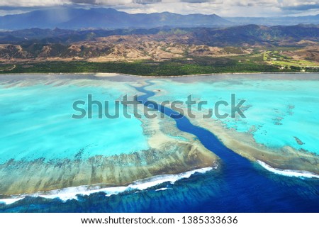 Aerial View of Poe corals reef and mountains in New Caledonia Island
