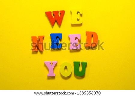 we need you written with wooden  colored letters on yellow background