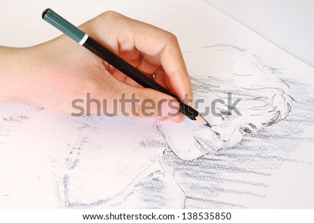 Sketching a Woman's Face with a Pencil Royalty-Free Stock Photo #138535850