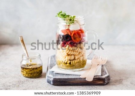 Italian Pasta Salad in a Jar with Salami, Cherry Tomatoes and Mini Mozzarella, copy space for your text
