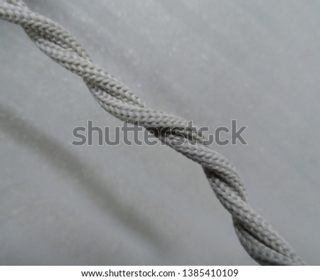 twisted gray rope on the gray background