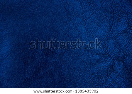 Dark blue textured leather background. Abstract leather texture. Top view.