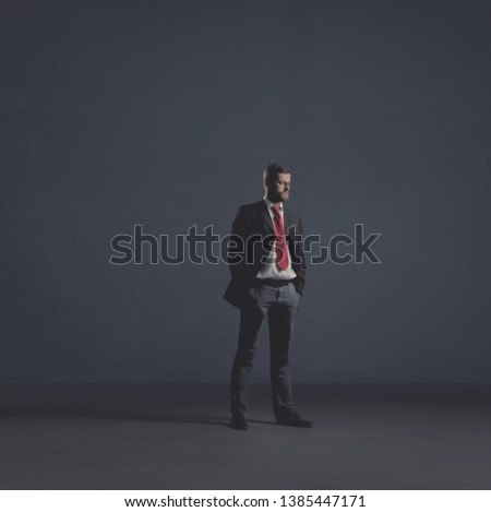 Businessman in formalwear over dark background. Business, finance, career and office concept.