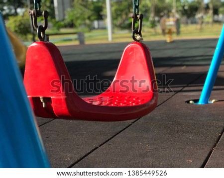 Red swings in the playground. Lonely and relax.