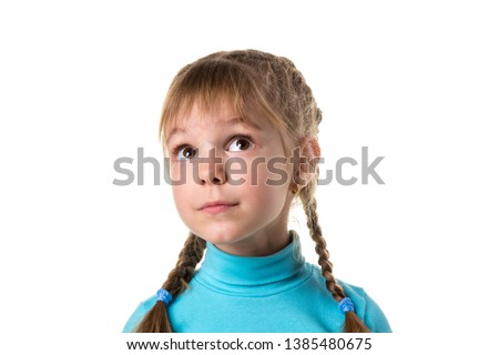 Portrait of a young dreamy naive girl with big eyes, looking up. Girl with two braids, isolated on white landscape background Royalty-Free Stock Photo #1385480675